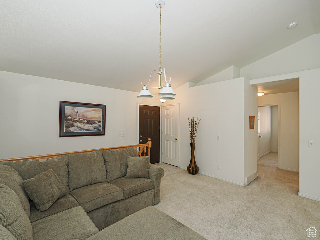 Living area with lofted ceiling and light carpet