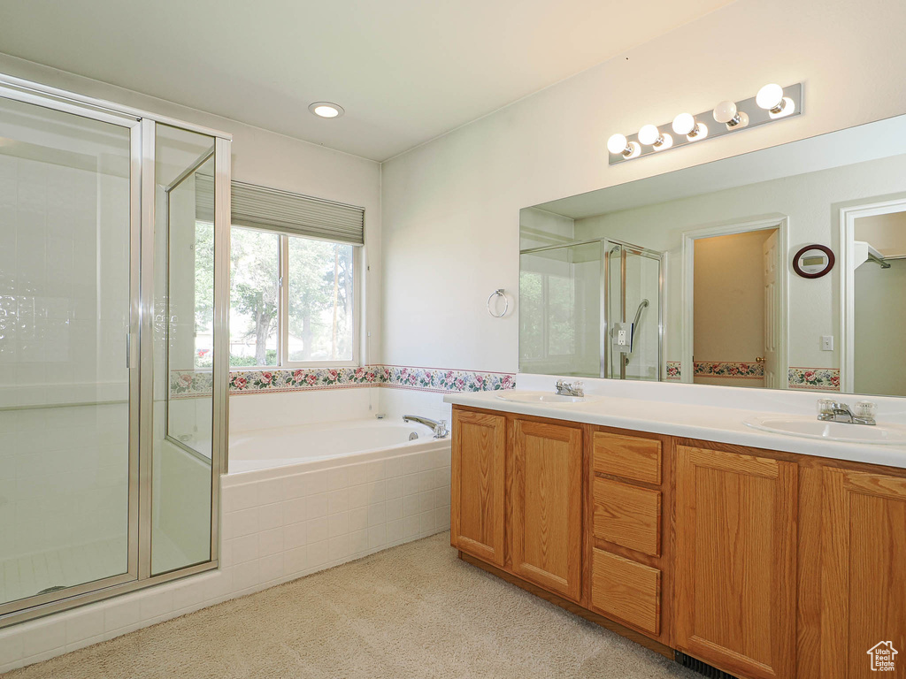 Bathroom with a stall shower, a bath, double vanity, and carpet floors