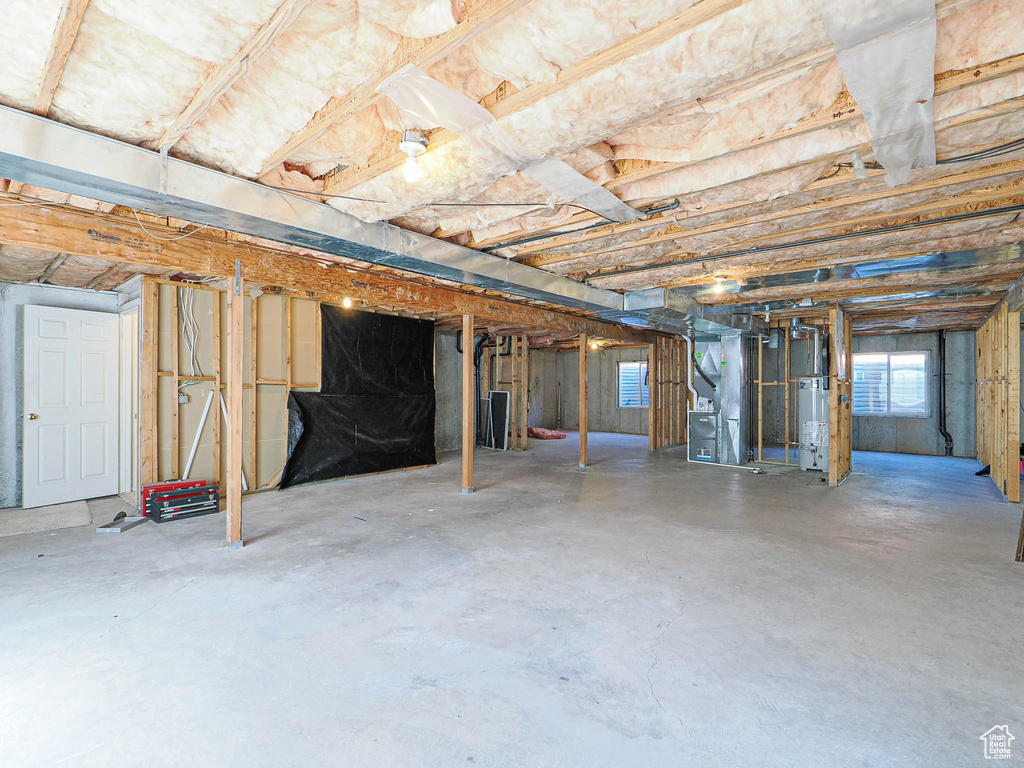 Below grade area with heating unit and gas water heater