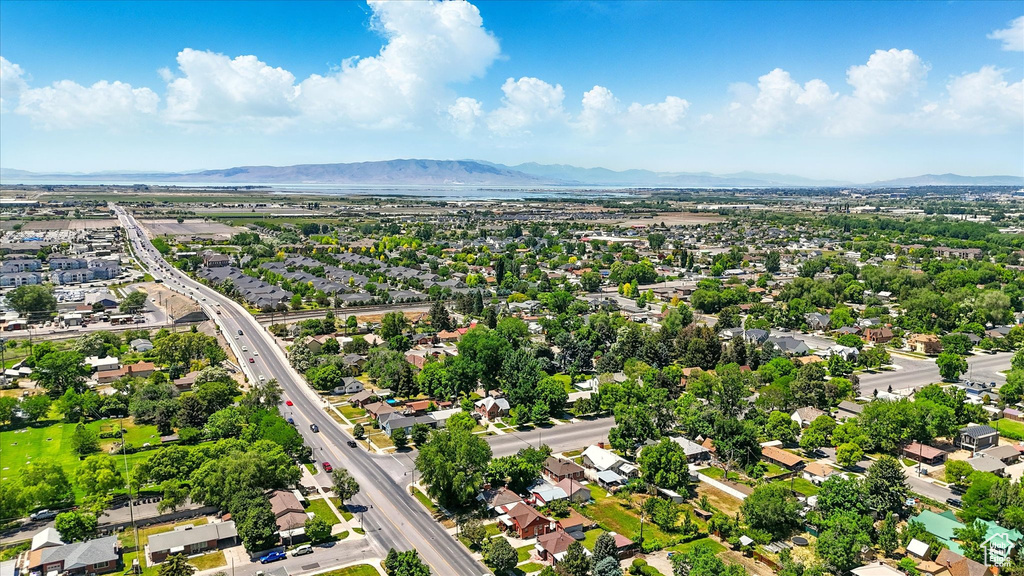Aerial view of residential area with a mountainous background and a major roadway