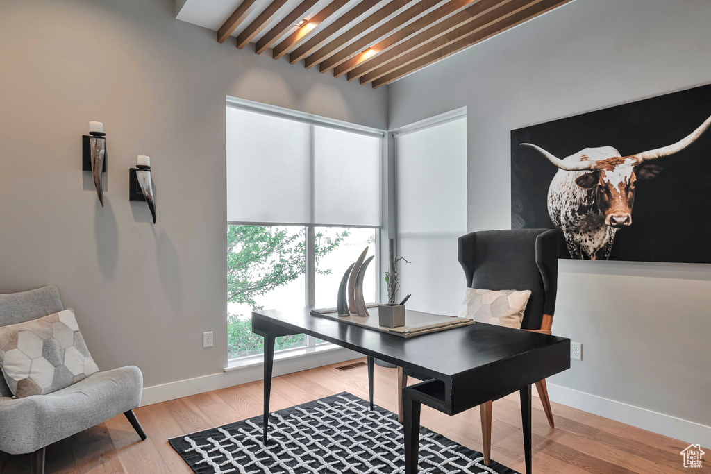 Office area featuring beamed ceiling and light wood-type flooring