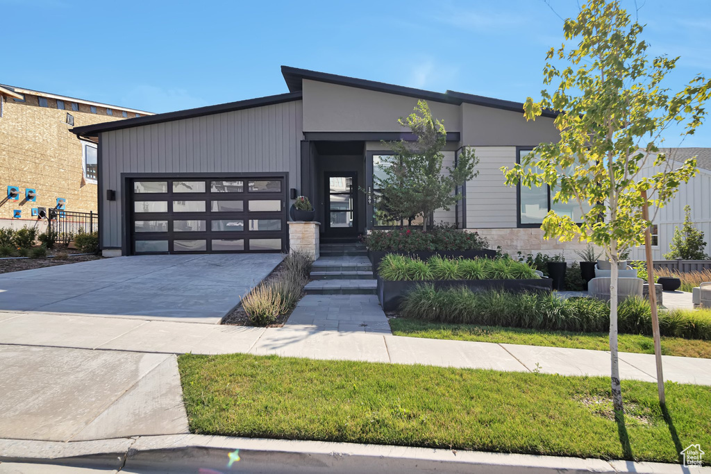 View of front of home featuring driveway and an attached garage