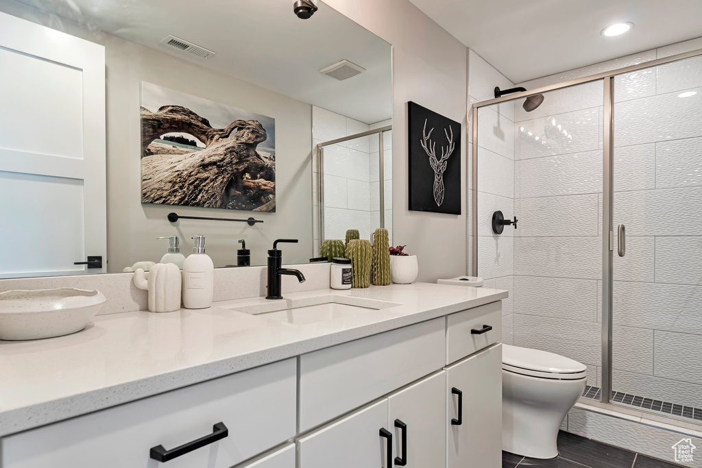 Bathroom with double vanity and a stall shower