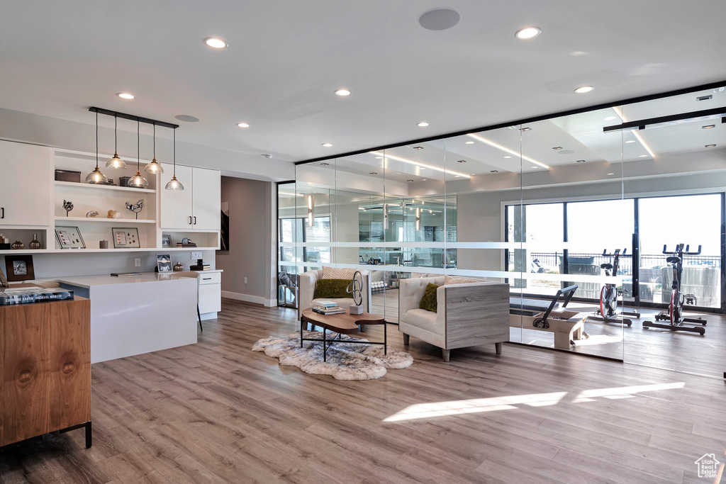 Living room featuring light wood finished floors and recessed lighting