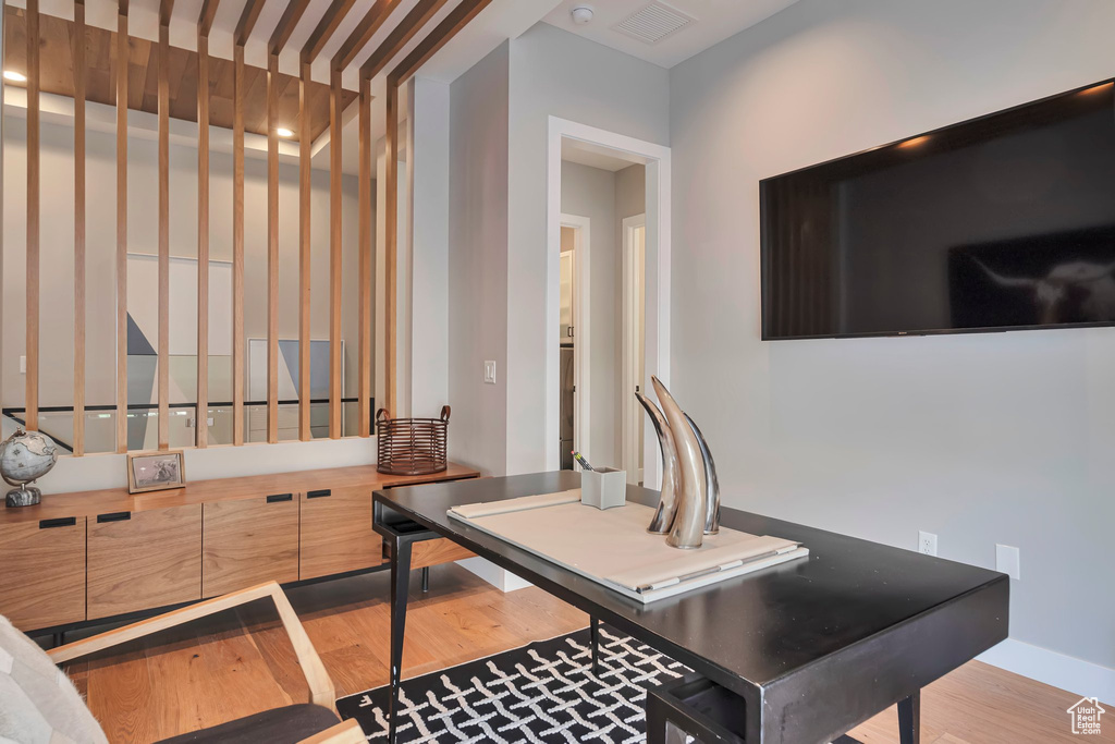 Home office with wood finished floors and baseboards