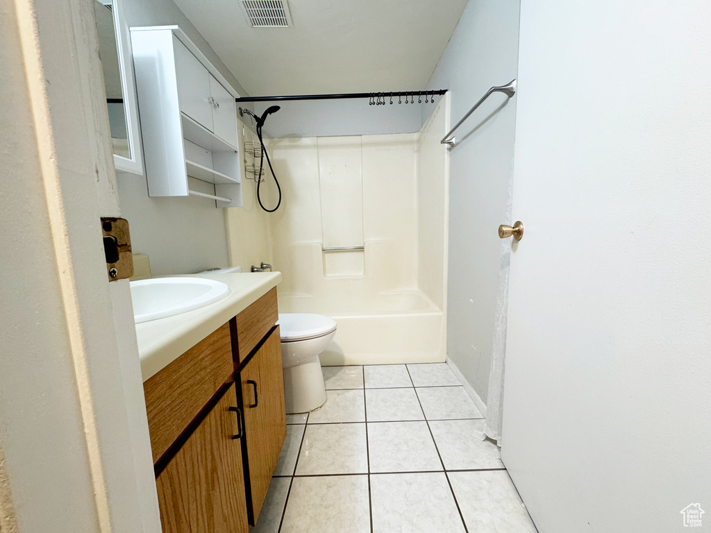 Full bathroom with vanity, toilet, tile patterned flooring, bathtub / shower combination, and baseboards