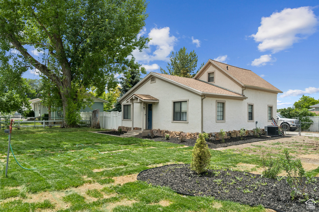 View of side of home with stucco siding and a shingled roof
