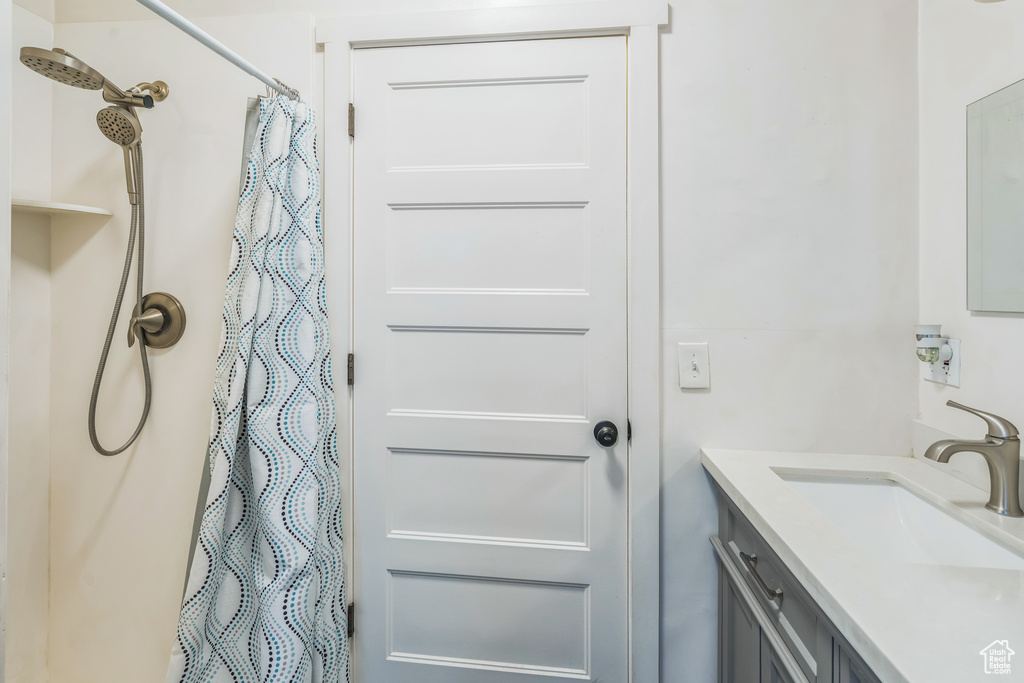 Full bath with vanity and curtained shower