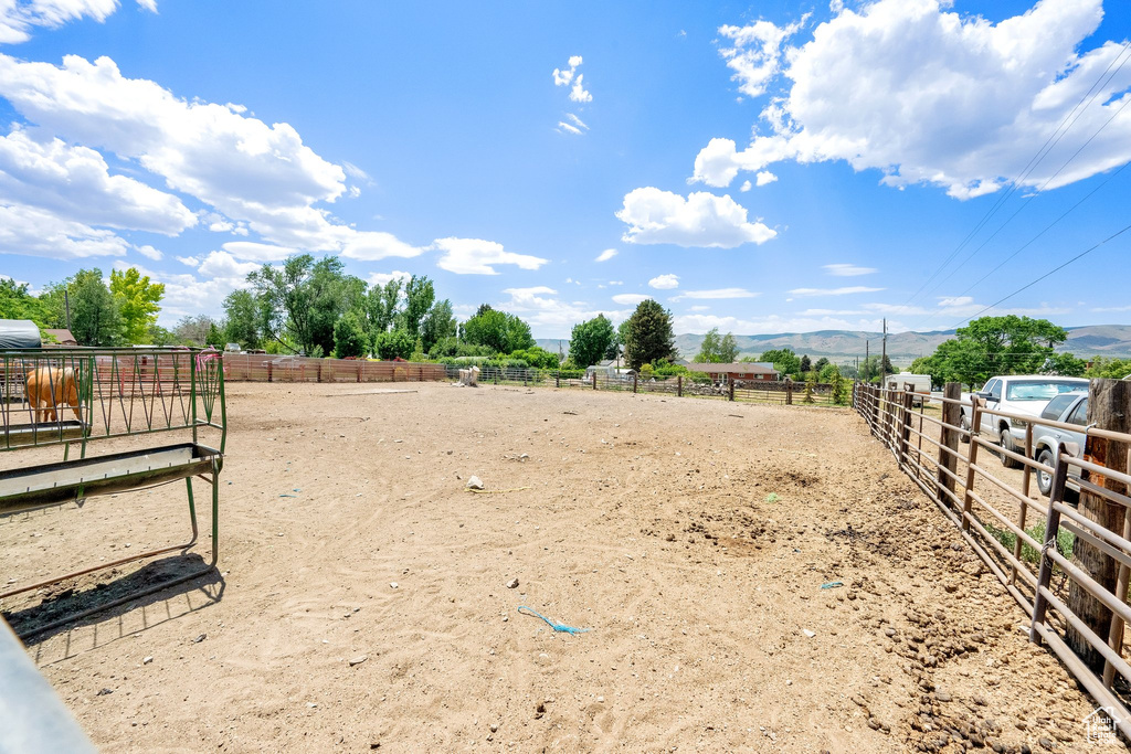 View of yard featuring an outdoor riding arena, a view of countryside, and a mountain view