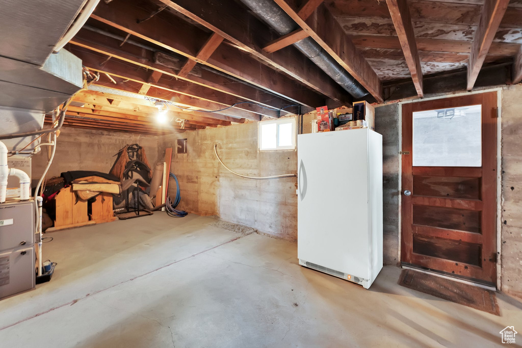 Below grade area with freestanding refrigerator