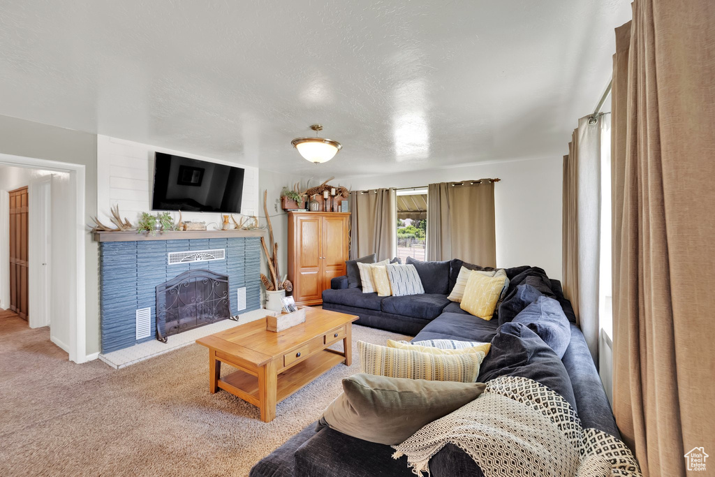 Carpeted living room with a fireplace