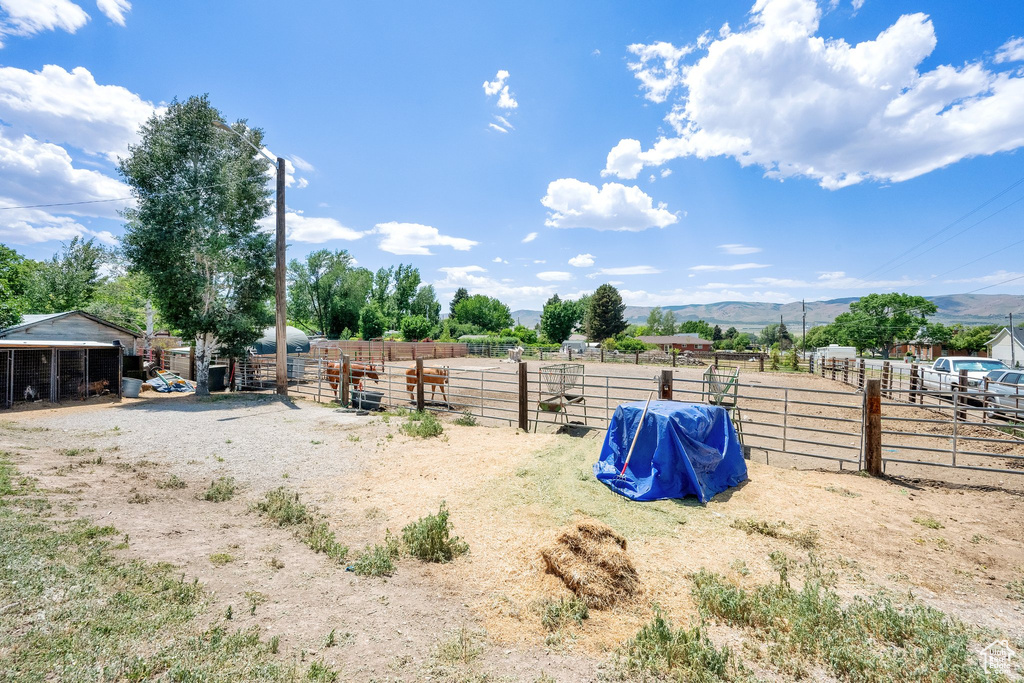View of yard featuring a mountain view, an exterior structure, and an outdoor structure