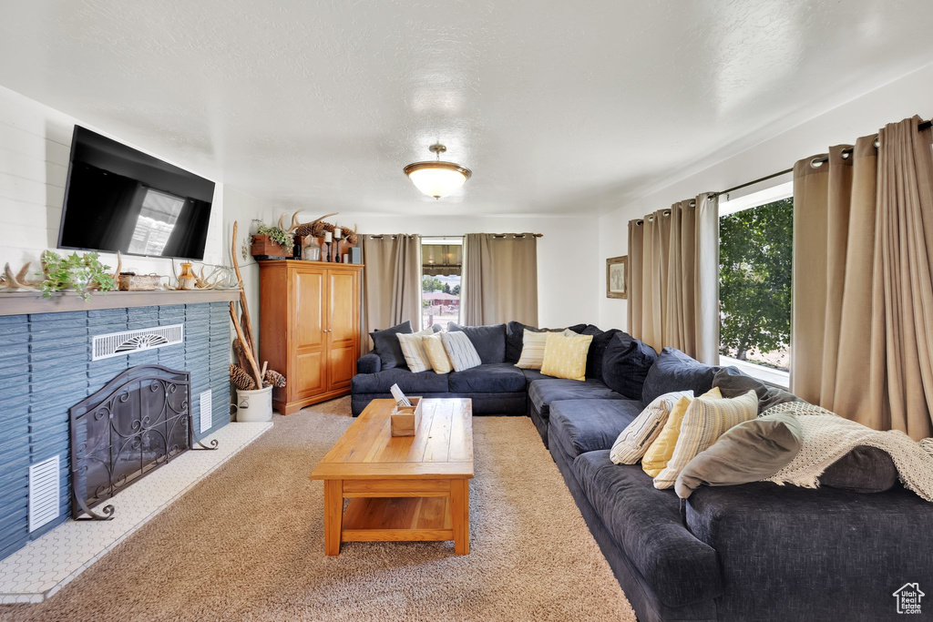 Living area with carpet floors and a fireplace