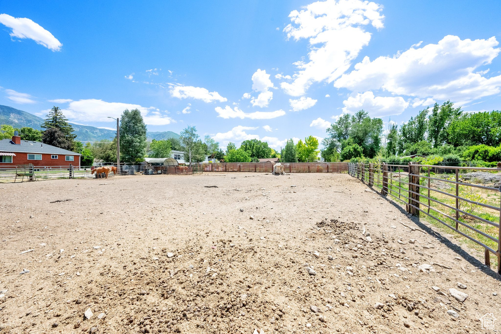 View of yard featuring an enclosed horse arena and a mountain view