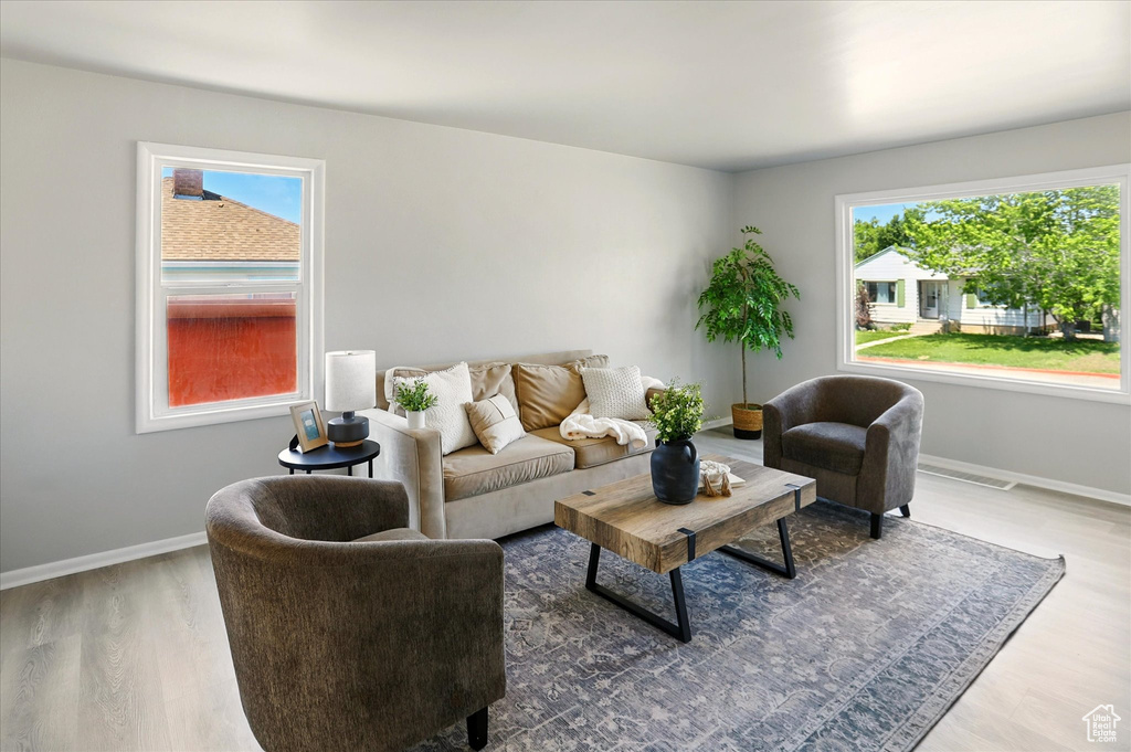 Living area featuring plenty of natural light and wood finished floors