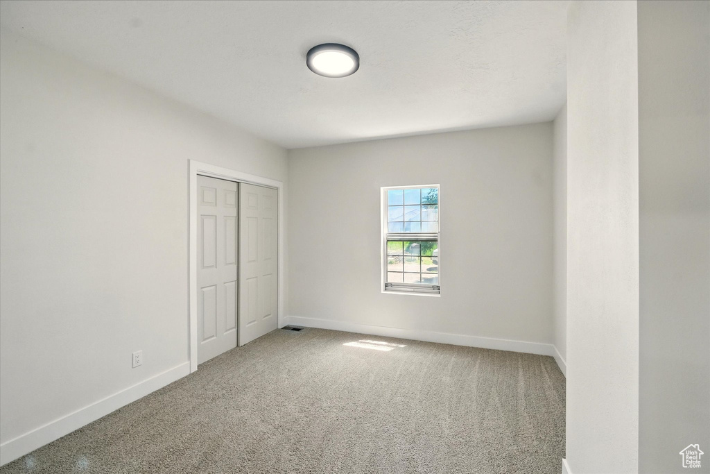 Unfurnished bedroom with carpet floors and a closet
