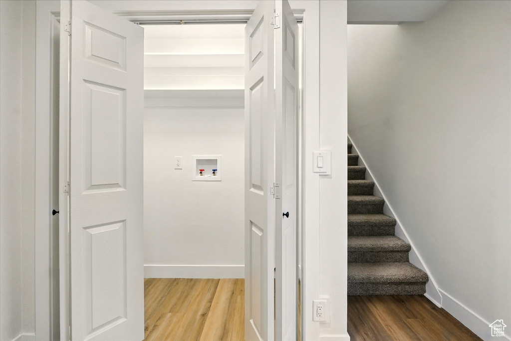 Stairs featuring wood finished floors and baseboards