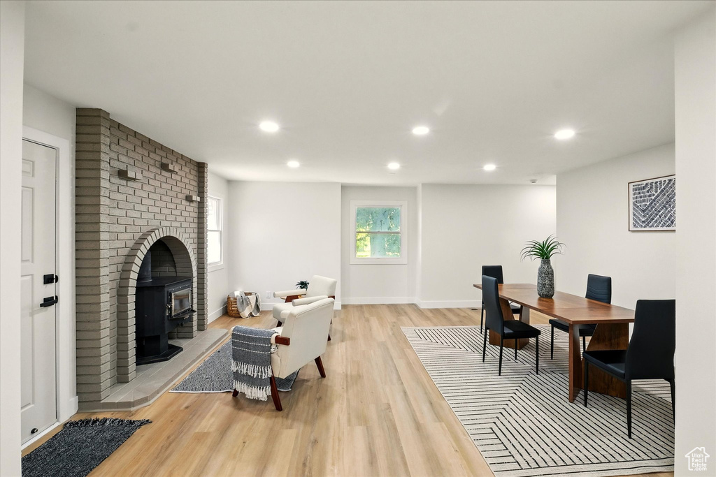 Living room with light wood-type flooring, recessed lighting, and a wood stove