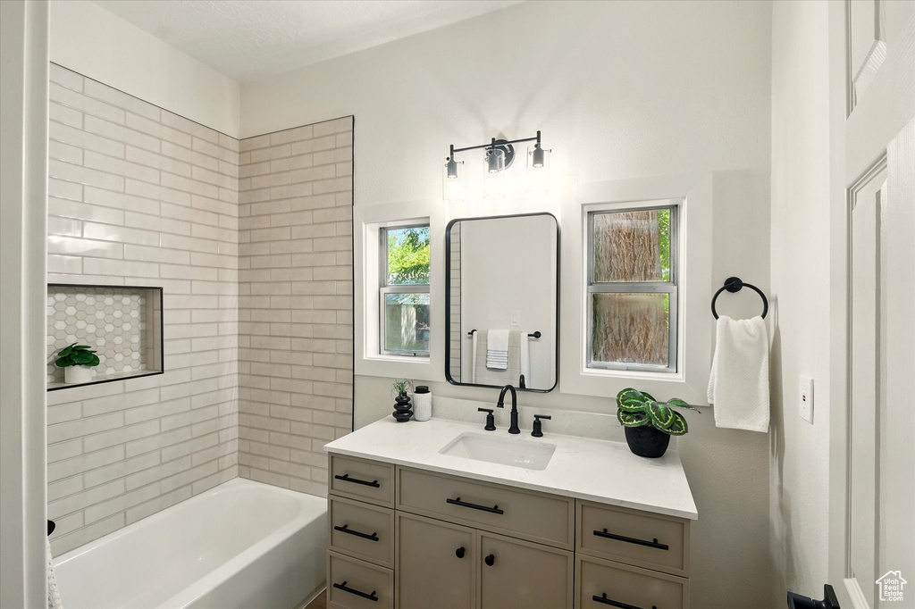 Bathroom featuring vanity and shower / bath combination