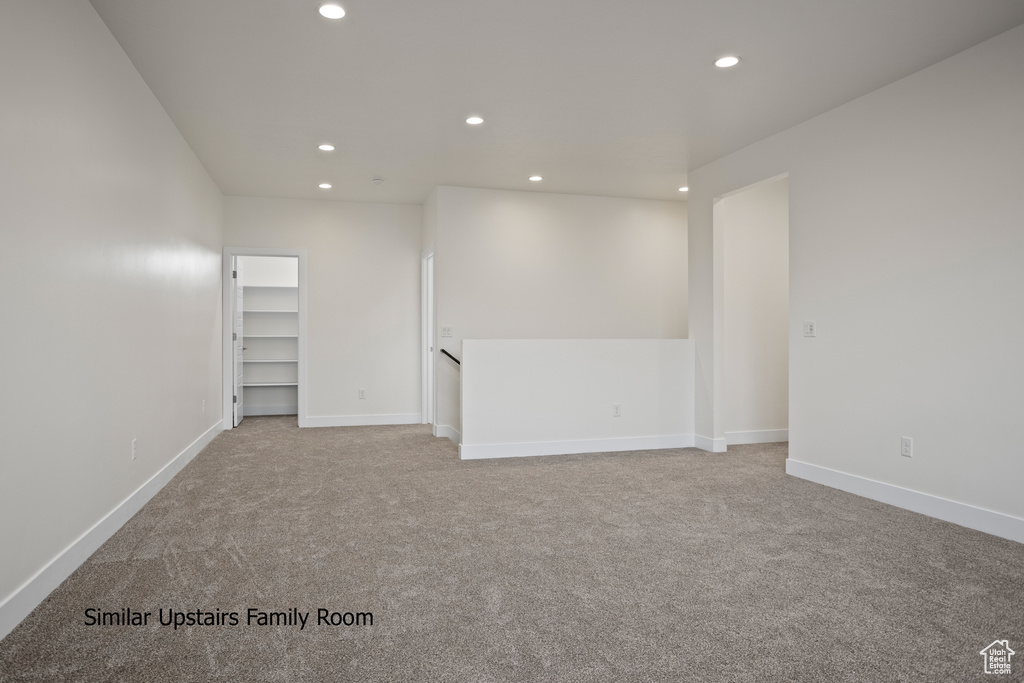 Carpeted spare room featuring recessed lighting