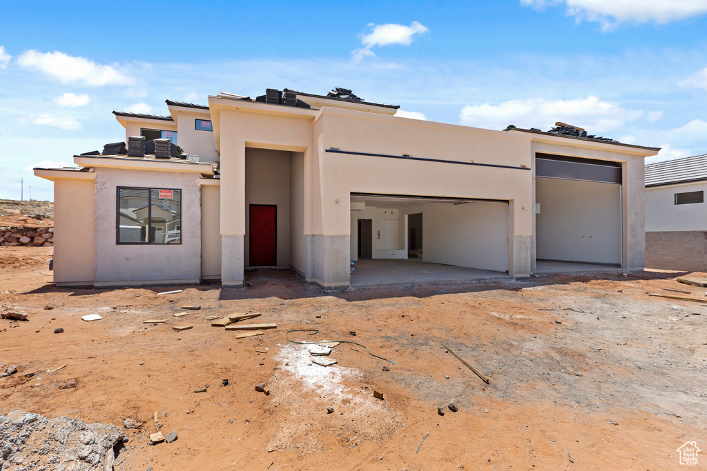 View of front of home with stucco siding and a garage