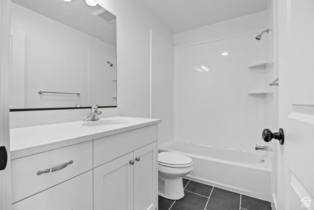 Bathroom with vanity, washtub / shower combination, and tile patterned floors