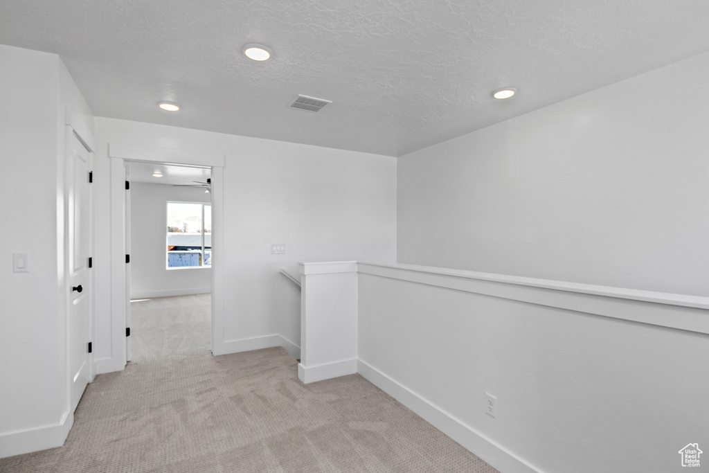 Unfurnished room featuring carpet, recessed lighting, and a textured ceiling