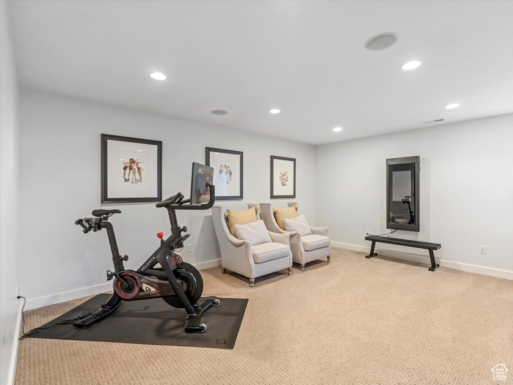 Exercise room featuring baseboards, recessed lighting, and light colored carpet