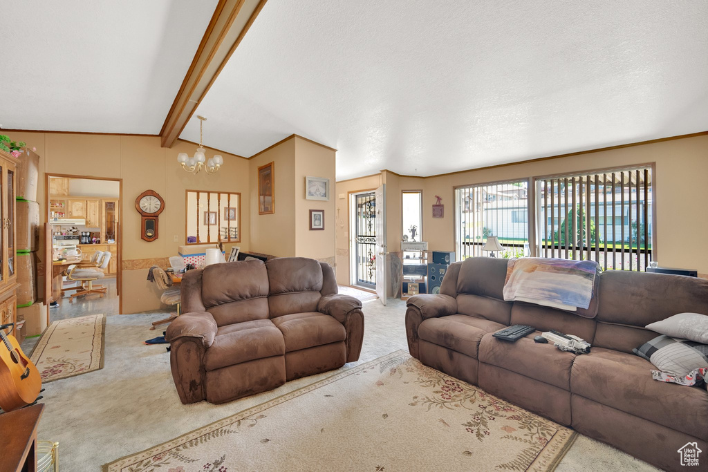Carpeted living room with a chandelier