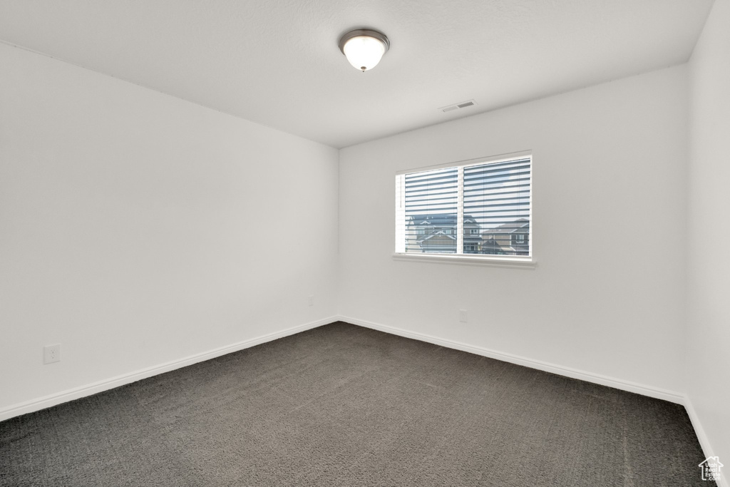 Empty room with dark carpet
