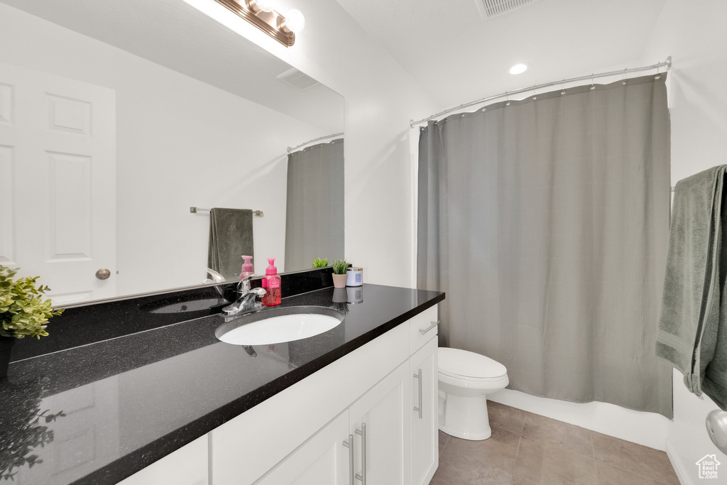 Bathroom with vanity, tile patterned floors, and shower / tub combo
