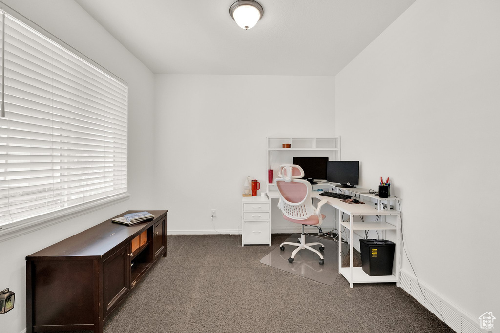 Carpeted office space featuring baseboards
