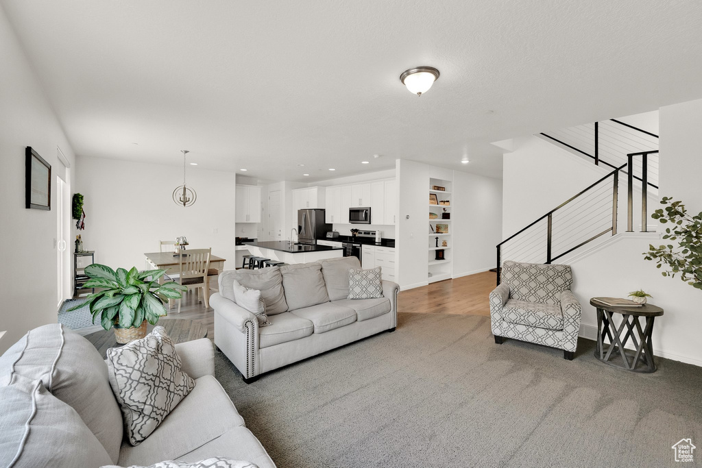 Living area with recessed lighting and stairs