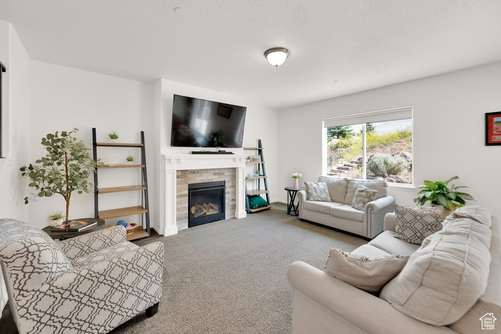 Living area with carpet floors and a tiled fireplace