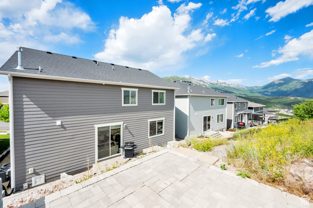 Rear view of property with a patio and a mountain view