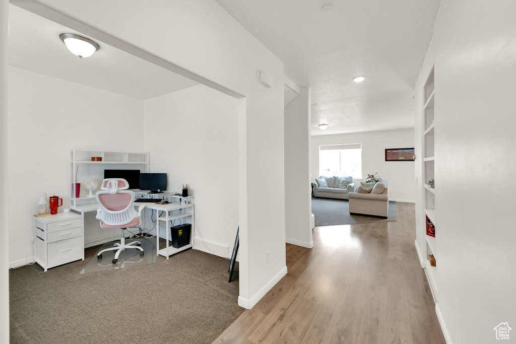 Office space featuring wood finished floors and recessed lighting
