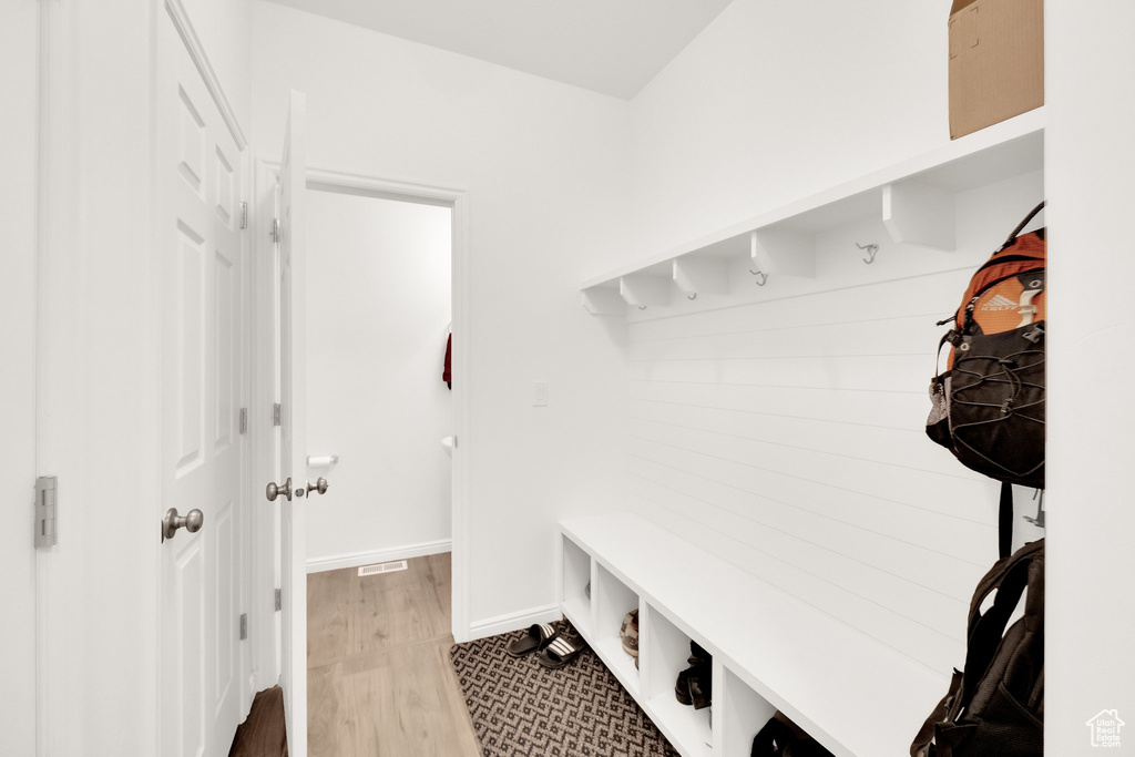Mudroom featuring baseboards and wood finished floors