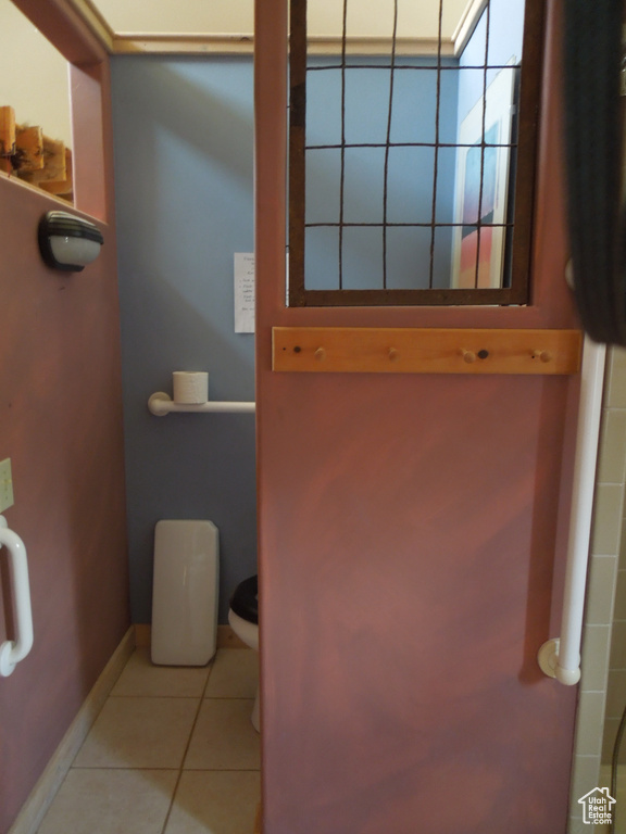 Bathroom featuring tile patterned flooring and toilet