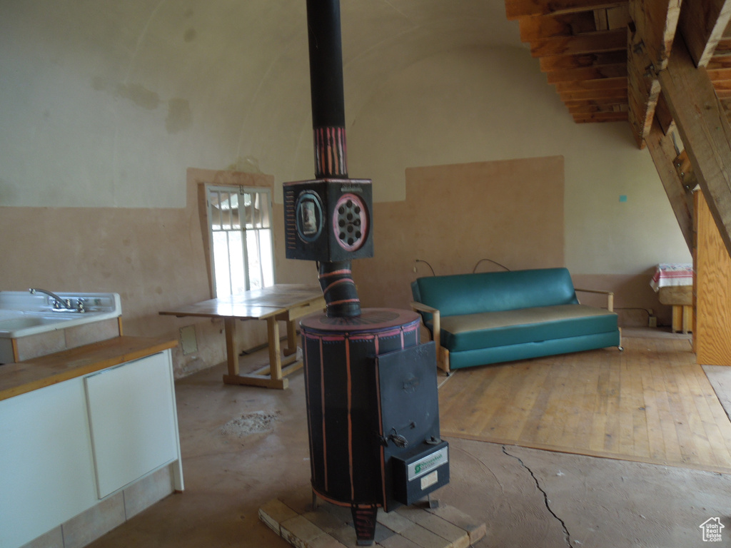 Below grade area with a wood stove and a sink