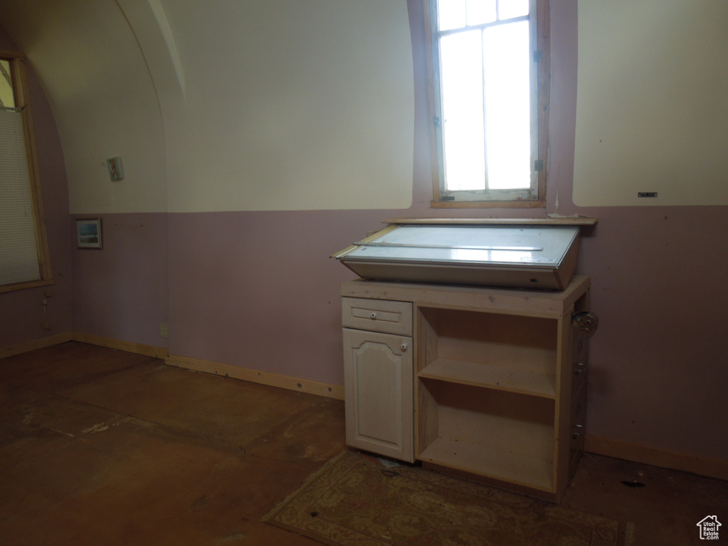 Kitchen with arched walkways and baseboards