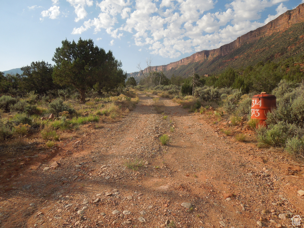 View of dirt / gravel road with a mountain view
