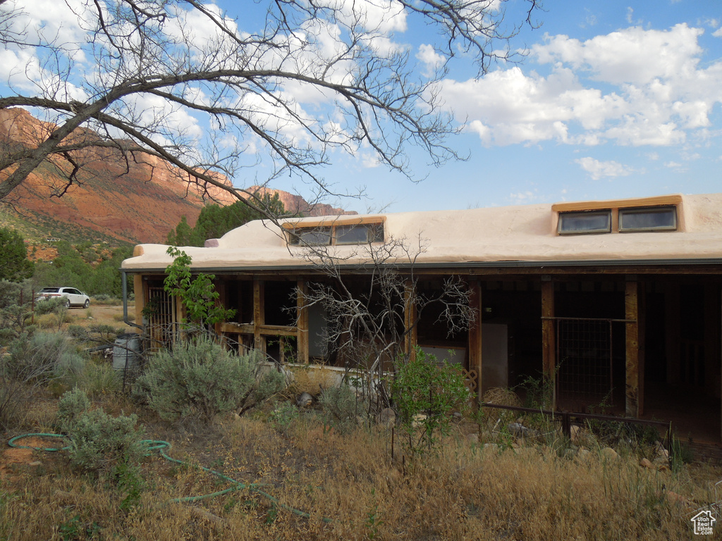 Back of house featuring a mountain view