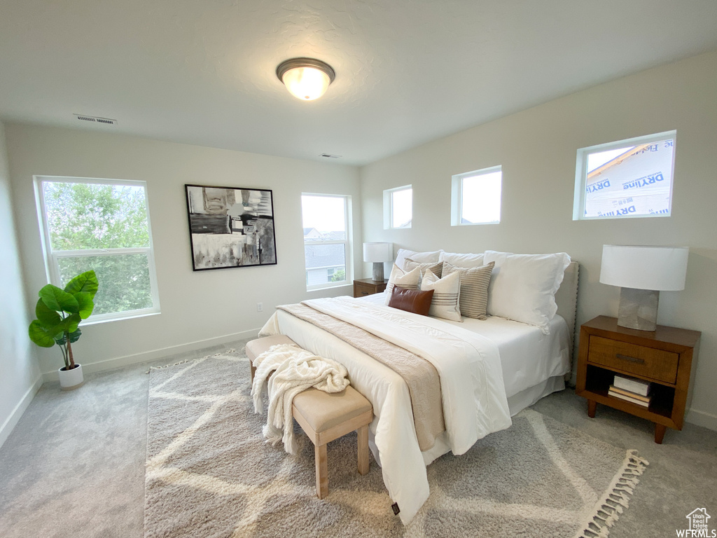 Bedroom with baseboards and carpet