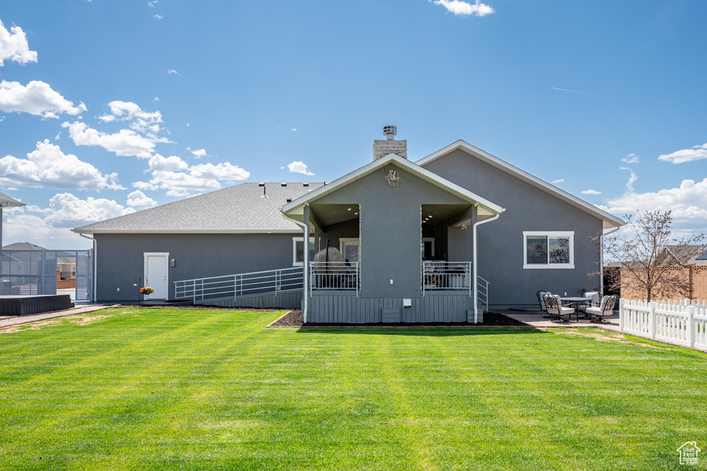 Back of house with a chimney, a fenced backyard, a patio, and stucco siding