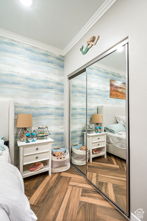Bedroom with crown molding and a closet