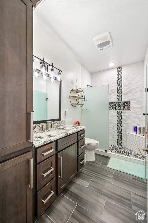 Bathroom featuring vanity and tiled shower