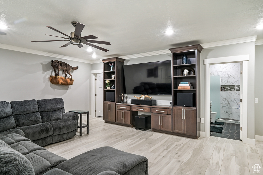 Living area with ceiling fan, crown molding, light wood finished floors, and recessed lighting