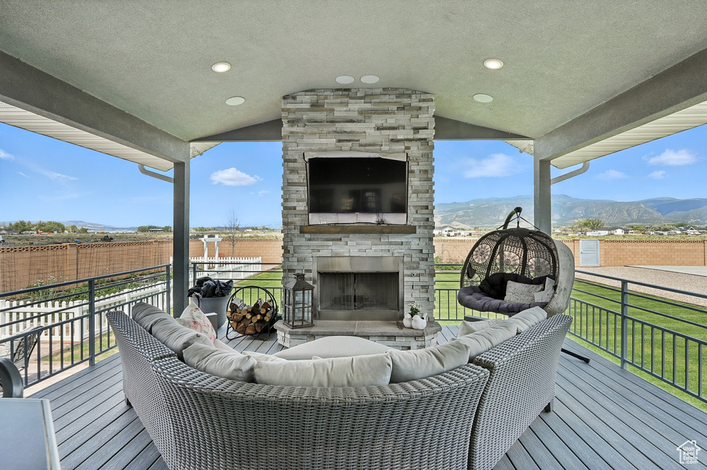 Deck featuring an outdoor living space with a fireplace