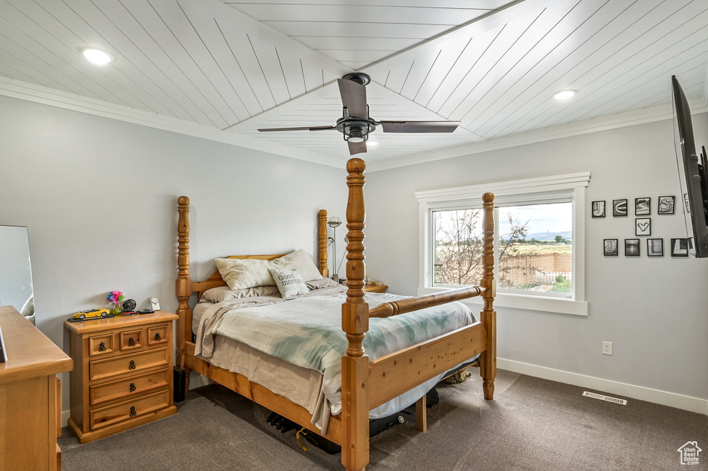 Bedroom with dark carpet, ornamental molding, recessed lighting, and ceiling fan