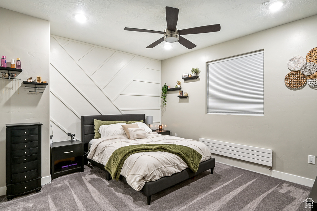 Carpeted bedroom with a baseboard radiator, recessed lighting, and ceiling fan